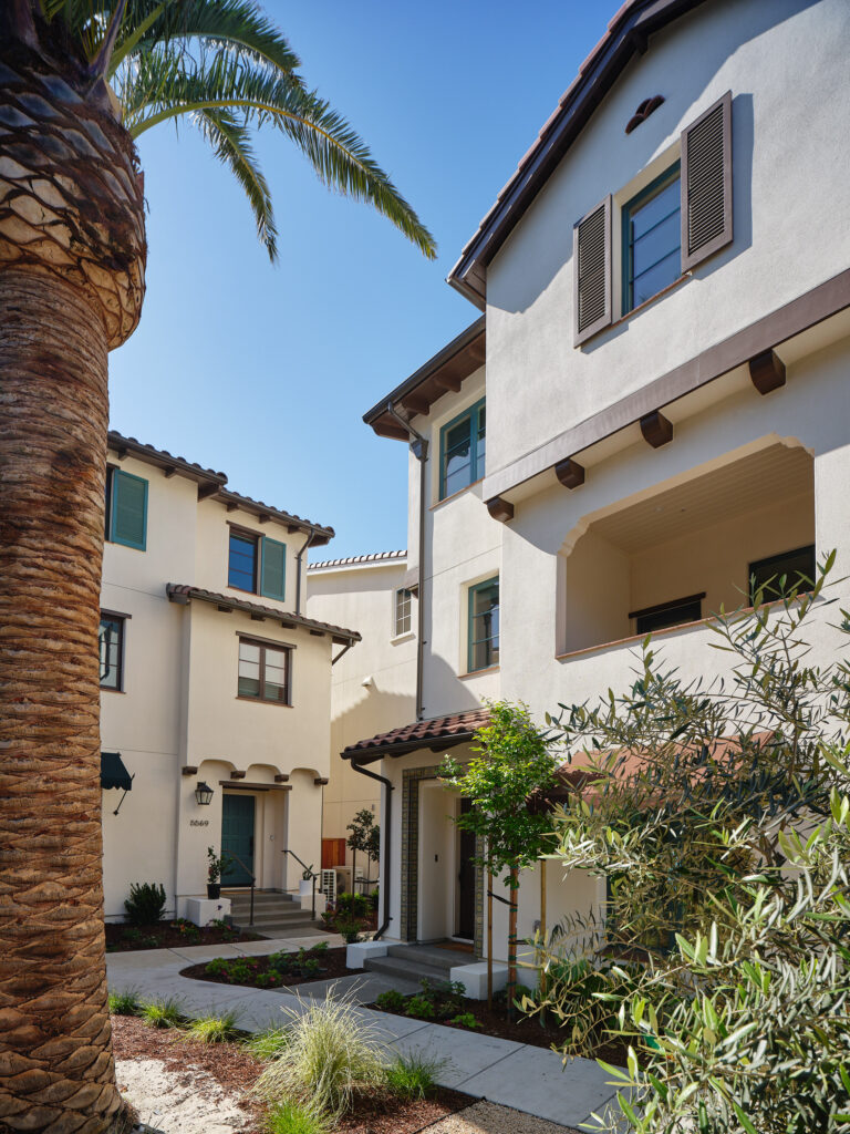 Front exterior of a Marabel home by Robson Homes with palm tree landscaping in Newark, CA