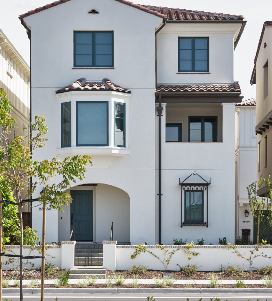 Front elevation of a white stucco Marabel home with bay window in Newark, CA