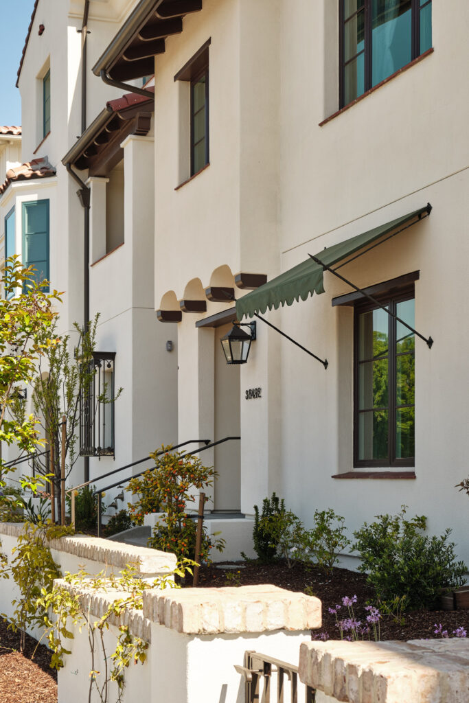 Front entry with green awning and stone steps at a Marabel home in Newark, CA