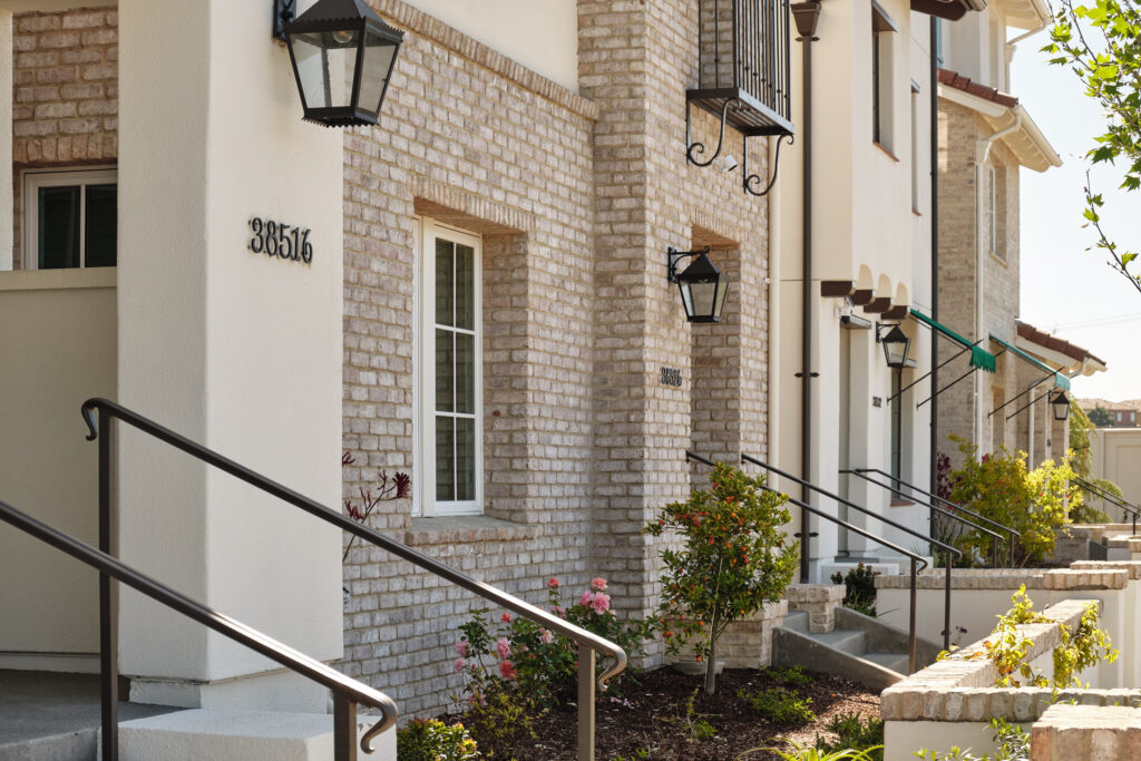 Brick-accented front entry of a Marabel townhome in Newark, CA
