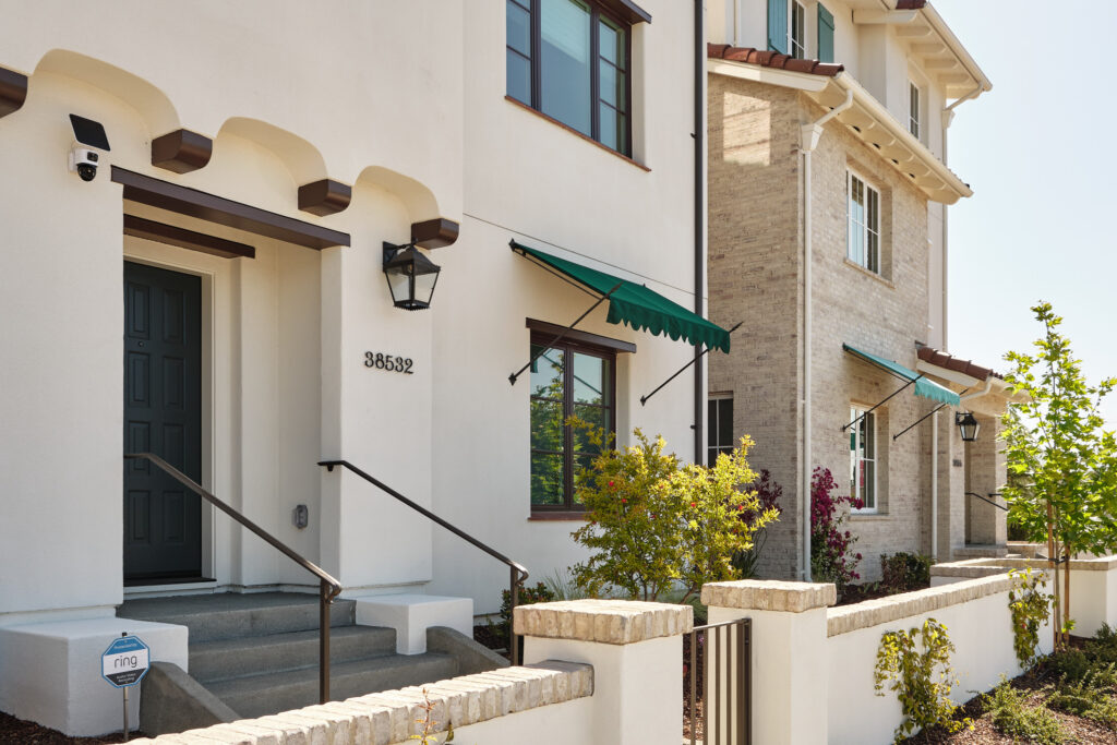 Arched front entry with teal awning at a Marabel home in Newark, CA