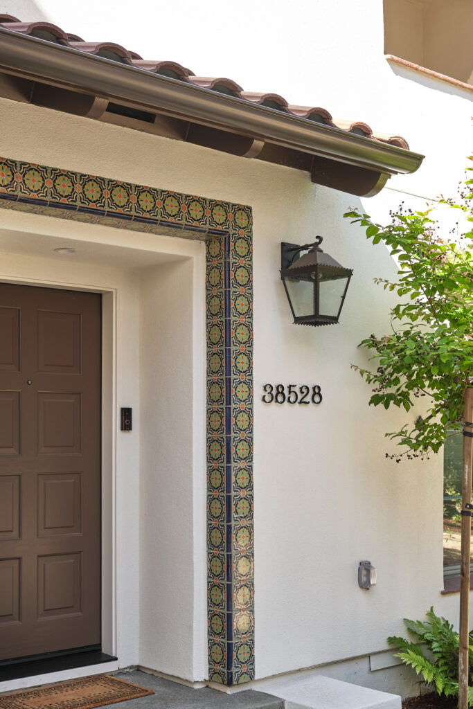 Front door with decorative tile surround at a Marabel home in Newark, CA