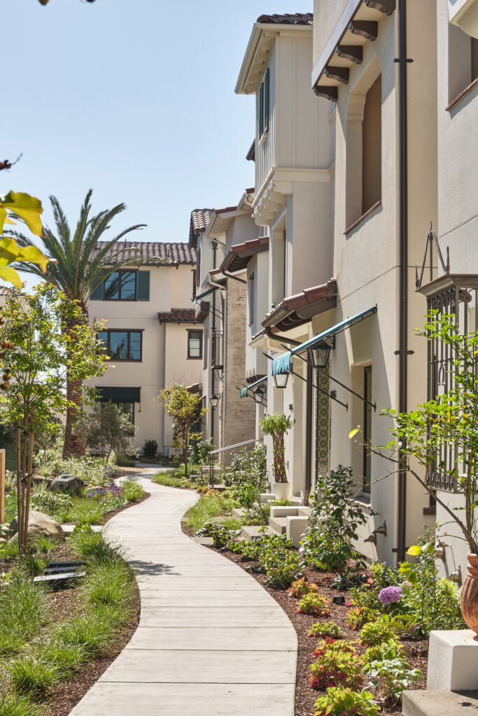 Paved walkway lined with landscaping between Marabel homes in Newark, CA