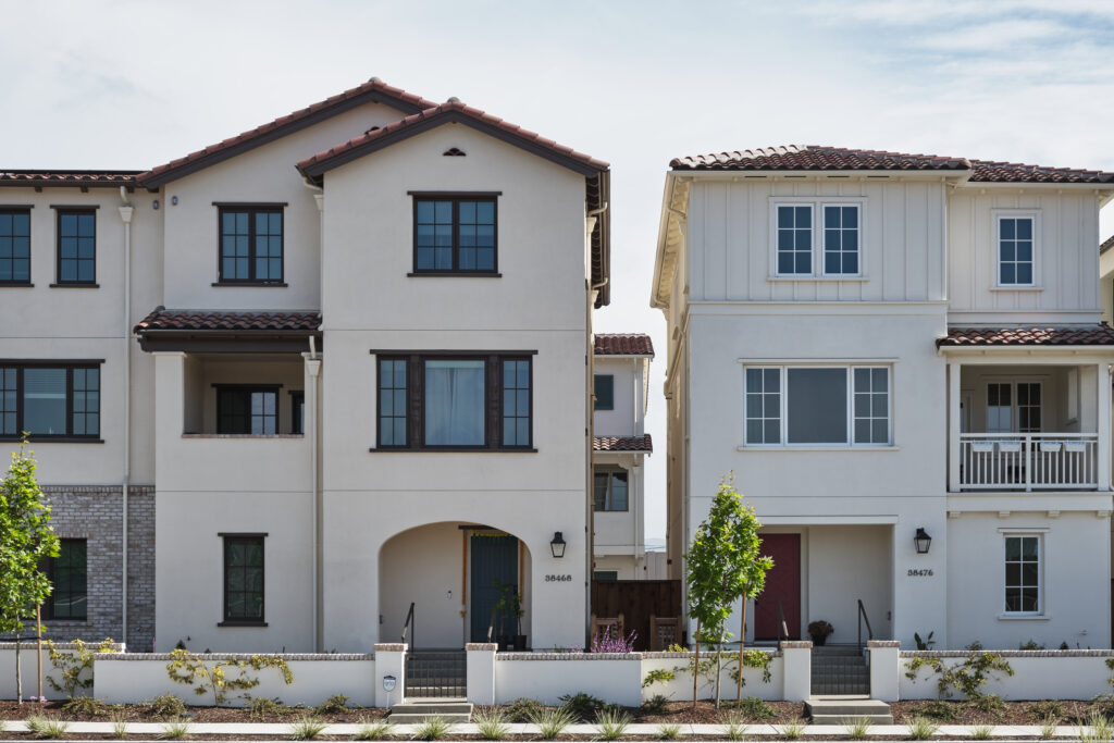 Street view of two adjoining Marabel townhomes with tile roofs in Newark, CA